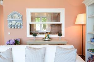 a living room with a white couch and a window at Villa Blue in Skala Potamias