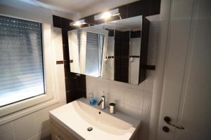 a bathroom with a sink and a mirror at Villa Blue in Skala Potamias +36 photos