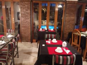 a restaurant with two tables and chairs with red napkins at La Magdalena in Mendoza