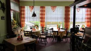 a restaurant with tables and chairs and a large window at Haus Kehrwieder - Hotel am Kur-Café in Bad Suderode