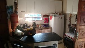 a kitchen with a counter with a pineapple on it at Casa temporada na praia Joia do Atlântico - Ilhéus - Ba in Ilhéus