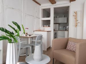 a small living room with a table and a chair at Studio Maison Verte Colmar Centre in Colmar