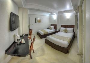 Кровать или кровати в номере Best Western Taxco