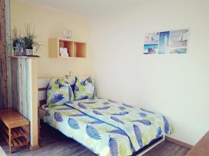 a bedroom with a bed with blue and white sheets at Studio 35 (Waren Müritz) in Waren