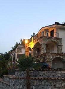 a house on top of a stone wall at Ruben holiday in Palinuro