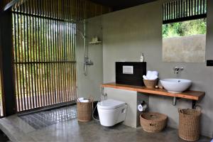 a bathroom with a toilet and a sink at Santani Wellness Kandy in Kandy