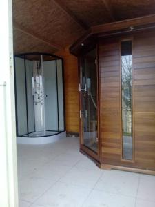 two glass elevators in a room with wood at Les Logis de l'Estuaire in Camoël +15 photos