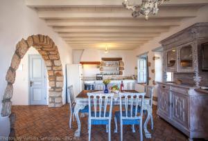 a kitchen with a table and chairs in a room at Theologos Houses in Grikos