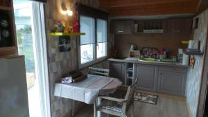 a small kitchen with a table and a window at Casa Bihan Ty Coat in Lannion