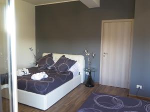 a bedroom with a bed with purple sheets and pillows at Symposium Bed&Breakfast in Catania