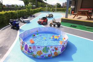 a toy swimming pool with toy cars and motorcycles at Dania Garden in Luodong
