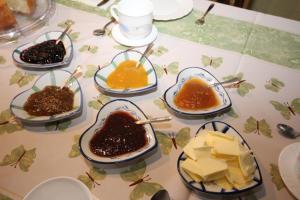 a table topped with bowls of different types of desserts at La Llosa in Villaviciosa