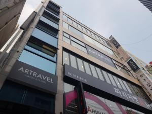 a building with signs on the side of it at Artravel Myeongdong in Seoul