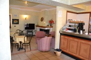 a kitchen and living room with a table and chairs at Albergo Due Monti in Ateleta