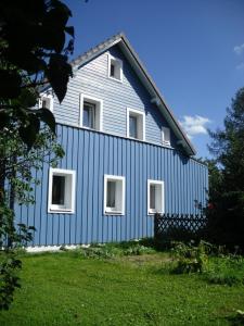 a blue house with white windows on the side of it at Ferienhaus Schwärzer in Bischofsgrün