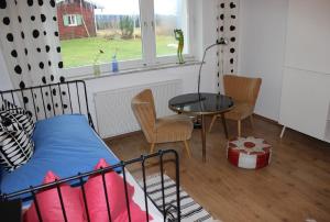 a bedroom with a bed and a table and a window at Ferienhaus Schwärzer in Bischofsgrün