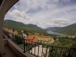 a balcony with a view of a town and a lake at Lago Vivo in Barrea