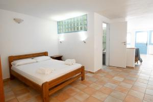 a bedroom with a bed with towels on it at Afroditi Pansion in Agios Nikitas