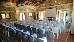 une chambre avec des rangées de chaises et un écran de projection dans l'établissement AGRITURISMO iL PIOPPETO, à Cassino