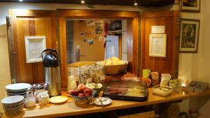 a kitchen counter with a table with food on it at Hostel Lollis Homestay Dresden in Dresden