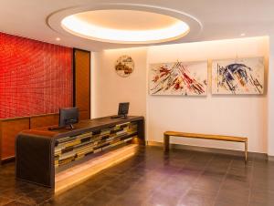 a reception desk in a room with paintings on the wall at Greatt Hotel in Taipei