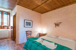 a bedroom with a bed and a table and a chair at B&B A Casa di Nonna in Padula