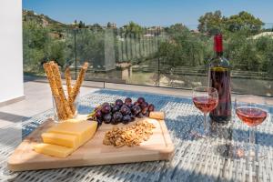 a table with cheese and wine and a bottle of wine at Maridenia Villa in Lithakia