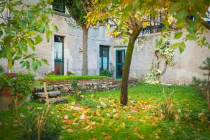 a house with a garden with flowers in front of it at B&B A Casa di Nonna in Padula