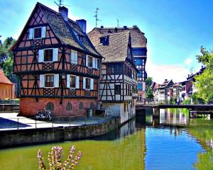 an old building next to a river in a city at Magnifique studio proche Cathédrale in Strasbourg