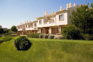 a large house with a lawn in front of it at Grande Real Santa Eulalia Resort & Hotel Spa in Albufeira