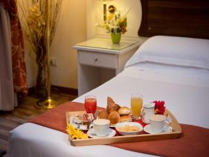 a tray of breakfast food on a bed at Residenza Domiziano in Rome