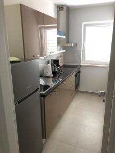 Kuchyň nebo kuchyňský kout v ubytování Apartmani Nada