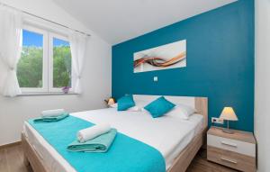 a bedroom with a large bed with blue walls at Corcyra Nigra Apartment in Blato