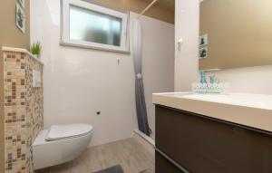 a bathroom with a toilet and a sink and a mirror at Corcyra Nigra Apartment in Blato +35 photos
