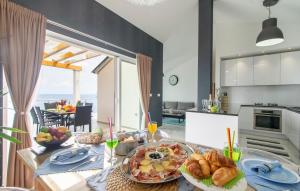 a kitchen with a table with a plate of food at Corcyra Nigra Apartment in Blato