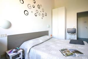 a bedroom with a large bed and a tv at Il Ghiro Guest House in Florence