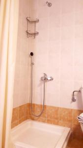a bathroom with a shower with a tub at Creta Spirit in Plakias