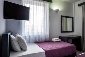 Postel nebo postele na pokoji v ubytování Galaxy Hotel