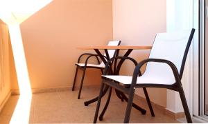 a table and two chairs in a room at Creta Spirit in Plakias
