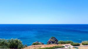 a view of the ocean with rocks in the foreground at Creta Spirit in Plakias