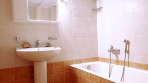 a bathroom with a sink and a bath tub at Creta Spirit in Plakias