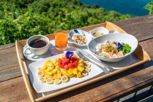 a tray with a plate of food on a table at Blue Heaven Resort Koh Tao in Ko Tao