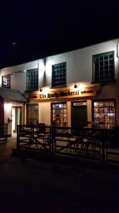 a building with benches in front of it at night at The Rusty Mackerel in Teelin
