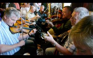 a group of people playing musical instruments on a bus at The Rusty Mackerel in Teelin