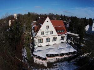 an aerial view of a building with a tent in front at Schlosshotel Grünwald in Grünwald