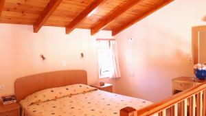 a small bedroom with a bed and a staircase at Creta Spirit in Plakias