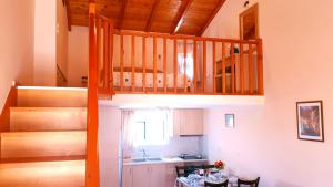 a kitchen with a staircase leading up to a loft at Creta Spirit in Plakias