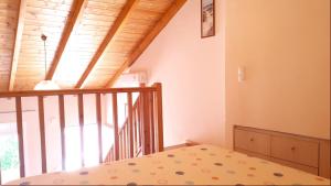 a small bedroom with a bed and a staircase at Creta Spirit in Plakias