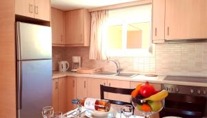 a kitchen with a bowl of fruit on a table at Creta Spirit in Plakias