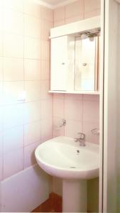 a bathroom with a white sink and a mirror at Creta Spirit in Plakias